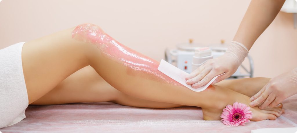 Close-up of a female leg being waxed, revealing smooth, shiny skin and highlighting hair removal for soft, flawless results